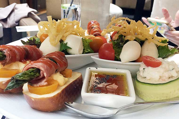 Caterpillar; cherry bocconcini & tomato on fresh green salad boat Alice in Wonderland Caterpillar; cherry bocconcini & tomato on fresh green salad boat Alice in Wonderland
