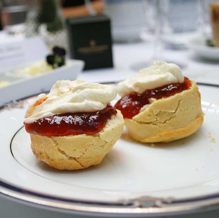 Freshly baked buttermilk and fruit scones with jam and cream