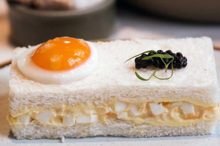 Classic egg mayonnaise, quail egg, avruga caviar on white bread