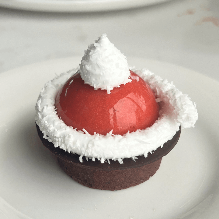 Raspberry Santa hat with spiced brulé chocolate tart, raspberry mousse & coconut marshmallow