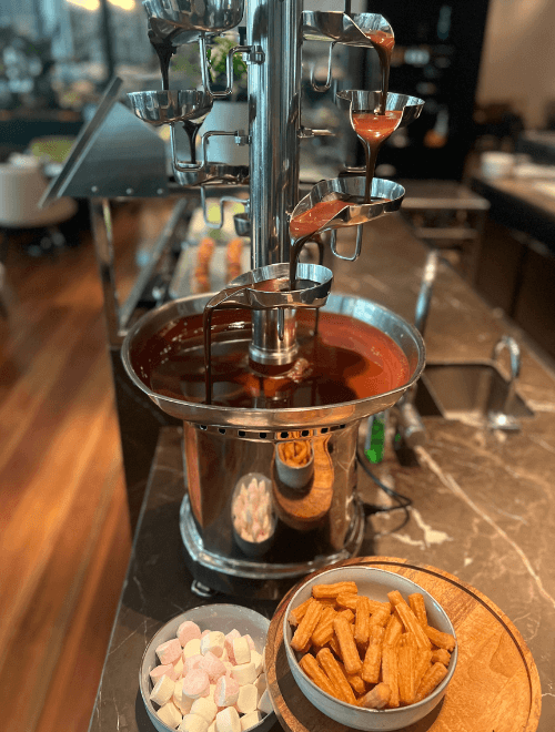 Dark chocolate fountain with churros and marshmallows