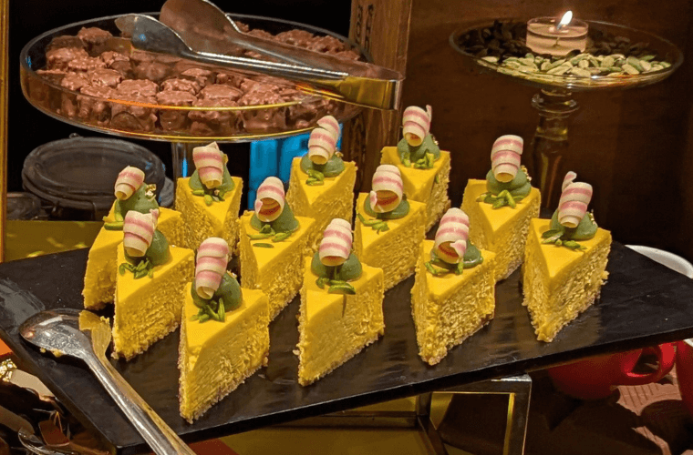 Mango cheese cake, pistachio ganache, pistachio slivers, gold leaf