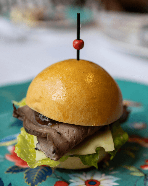Brioche bun, aged wagyu pastrami, swiss cheese, baby cos, caramelised onion
